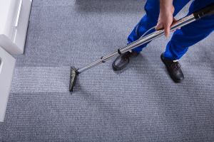 bigstock-janitor-cleaning-carpet-234805855